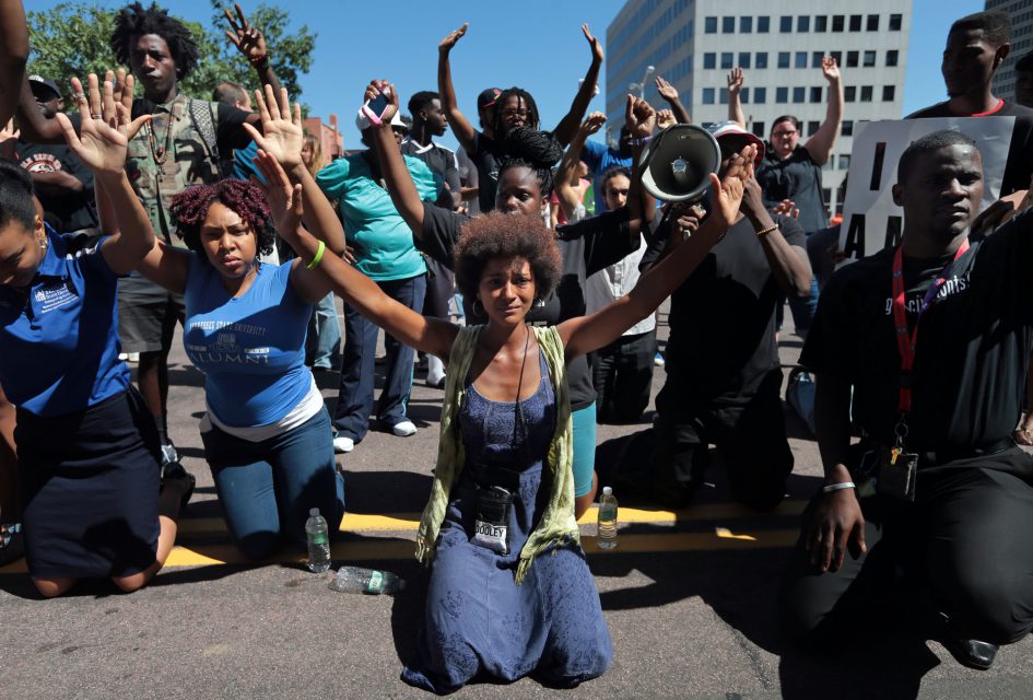 "I am out here because I am part of the masses of people in St. Louis and soon to be in the nation that is exhausted and fatigued with the progression of police genocide, it's not police brutality anymore, it's genocide against young black Americans," said Sunny Ford, during a rally on Tuesday, Aug.12, 2014, in Clayton, protesting the fatal shooting of Michael Brown by a Ferguson police officer. The protestors dropped to their knees and put their arms in the air to show the show Michael Brown who was said to be unarmed was shoot. Photo by Laurie Skrivan, lskrivan@post-dispatch.com