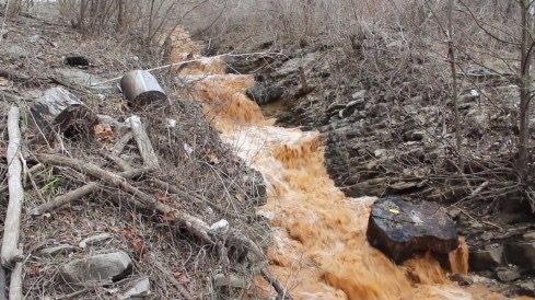 rust-colored water flowing in a stream