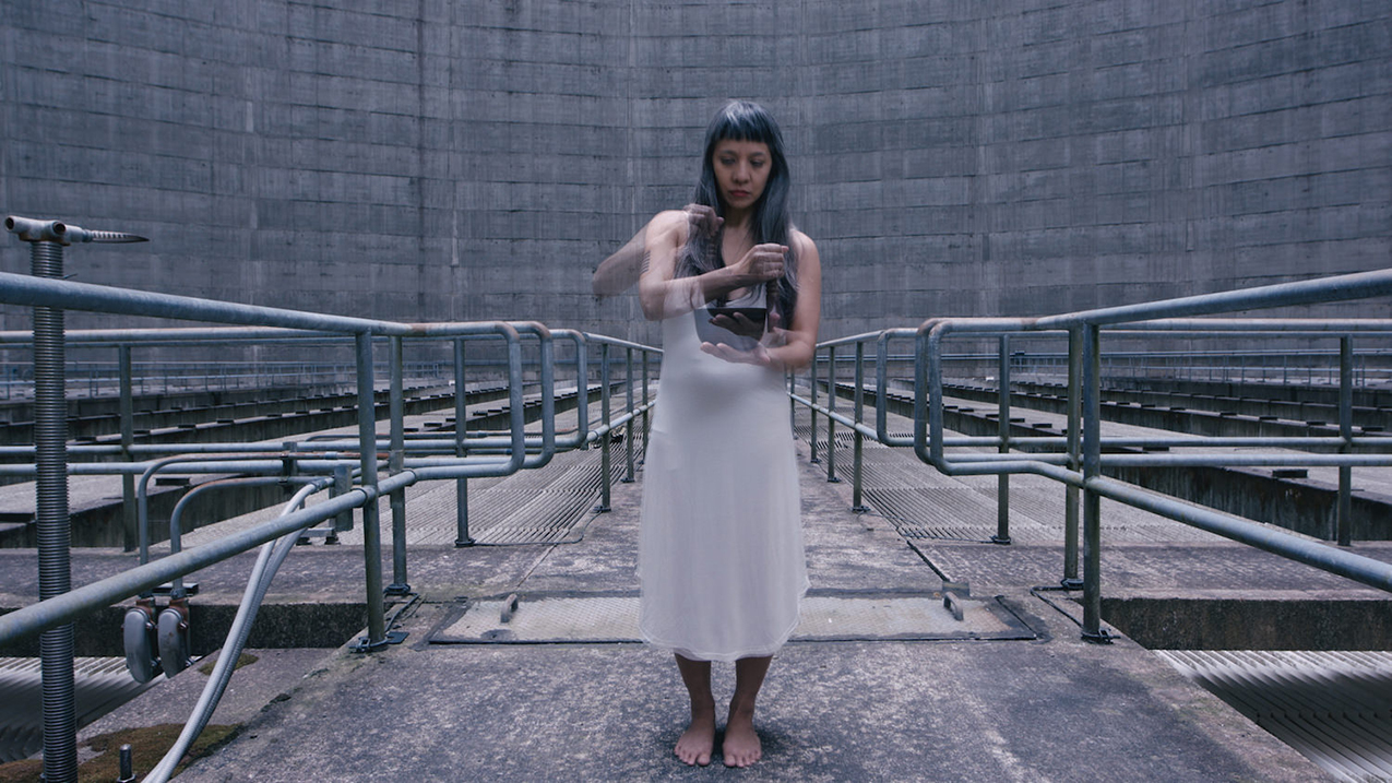 still from Traveler's Ode video: Dao Strom standing in white dress