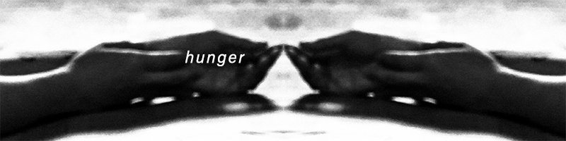 black and white photo of cupped hands with text "hunger"