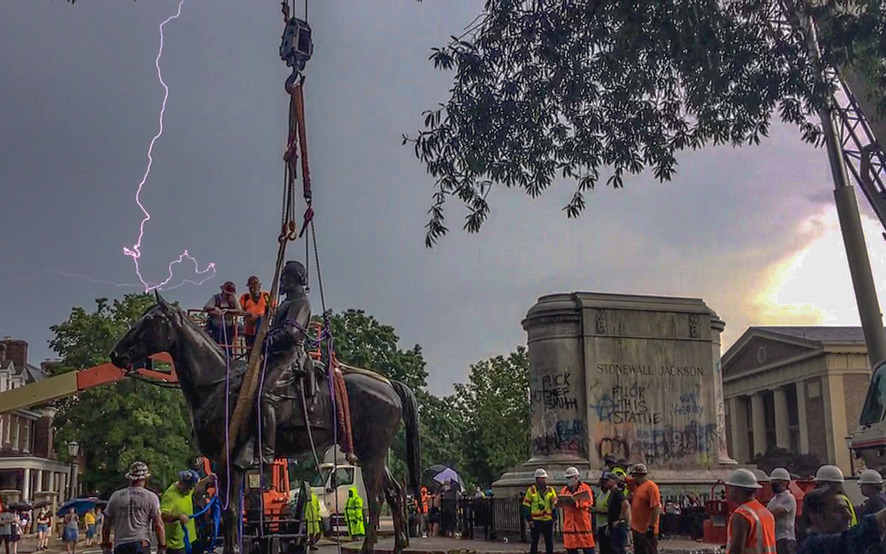 lightning strikes as a crew removes the Stonewall Jackson statue using a hoist
