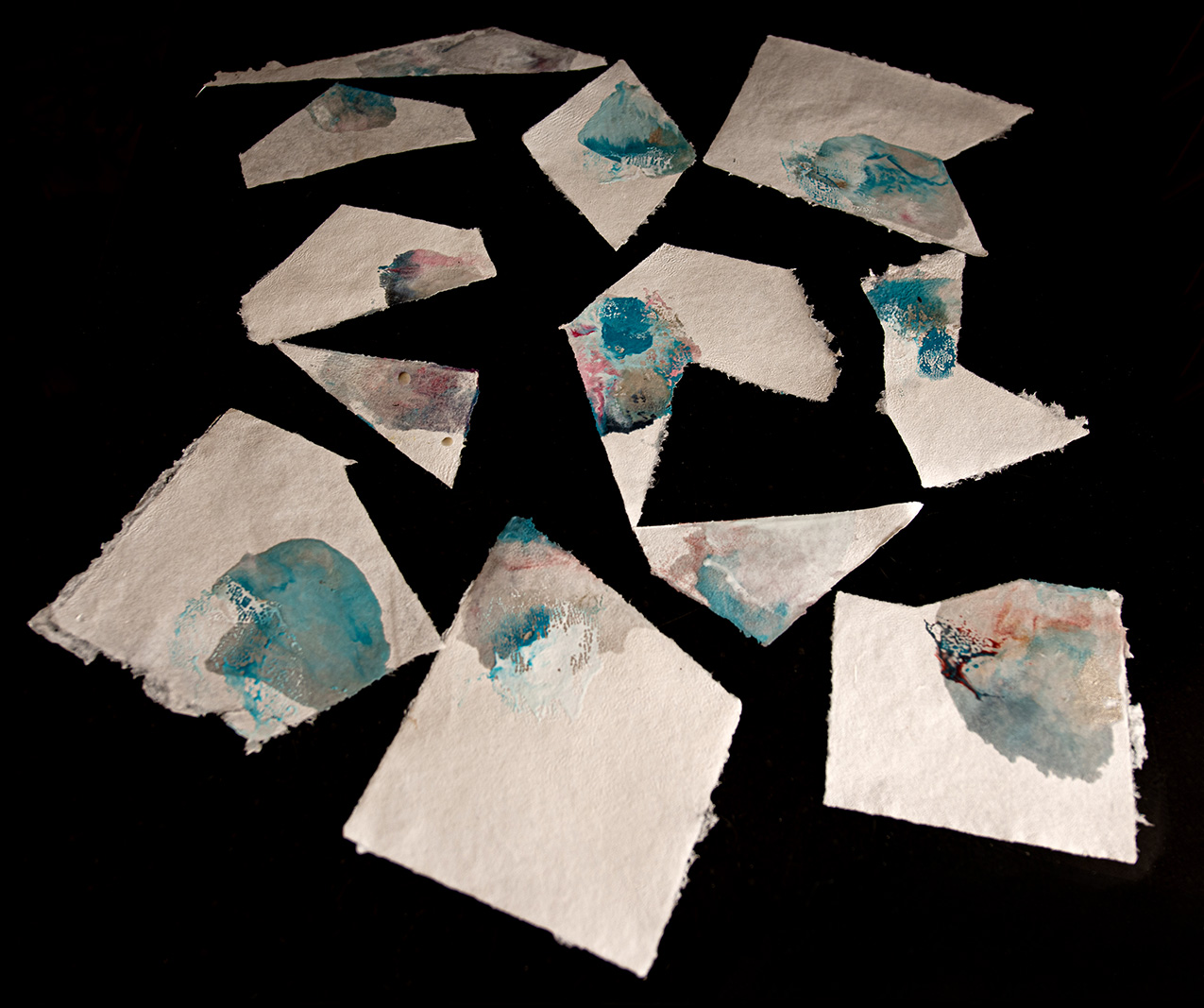 white handmade paper with blue and other multicolor accents
