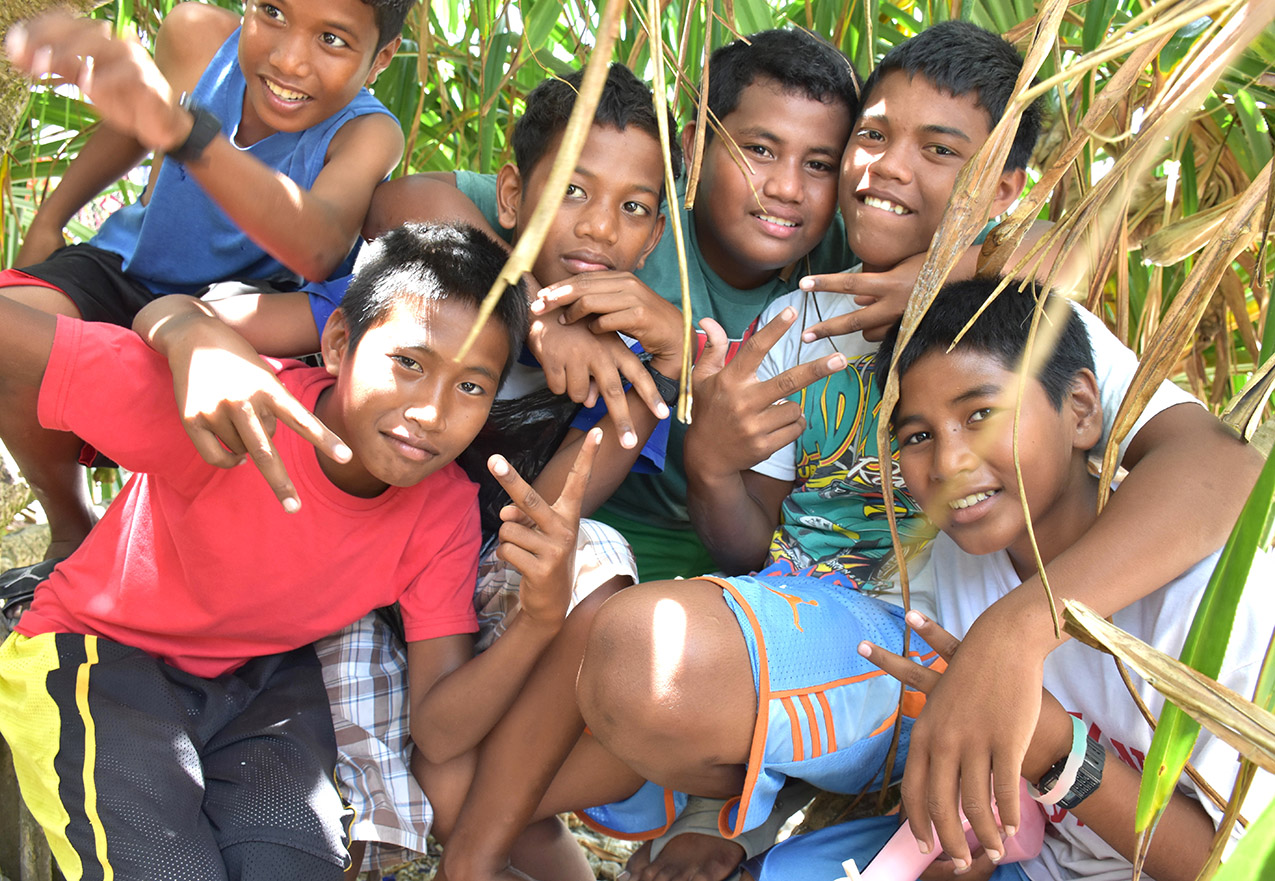six boys take a break from singing to pose for a picture in Majuro, Marshall Islands