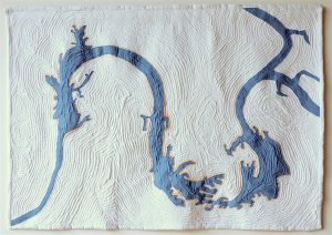 a map quilt featuring a blue river on a white background. the river's shape is dragon-like.