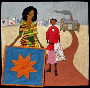pictorial quilt featuring a black woman proudly displaying a quilt. her sister stands behind her with a quilt slung over her arm. behind them is their home and yard where more quilts hang on clotheslines.