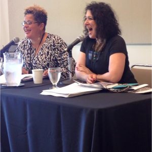two women speaking on a panel at BinderCon