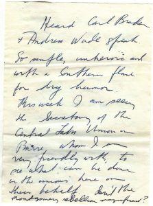 a yellowed piece of paper with hard-to-read cursive handwriting in dark blue pen