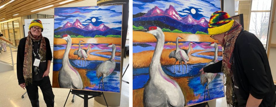 a person standing next to the Over the Tetons painting