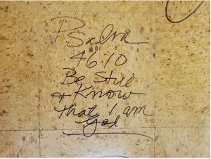 handwritten on a floor tile: Psalm 46:10 Be still and know that I am God